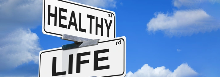 Background of blue sky with clouds and signs that say 'Health' and 'Life'.