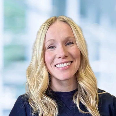 Dr. Brielle Egilson portraid with loose blonde hair and a big smile.